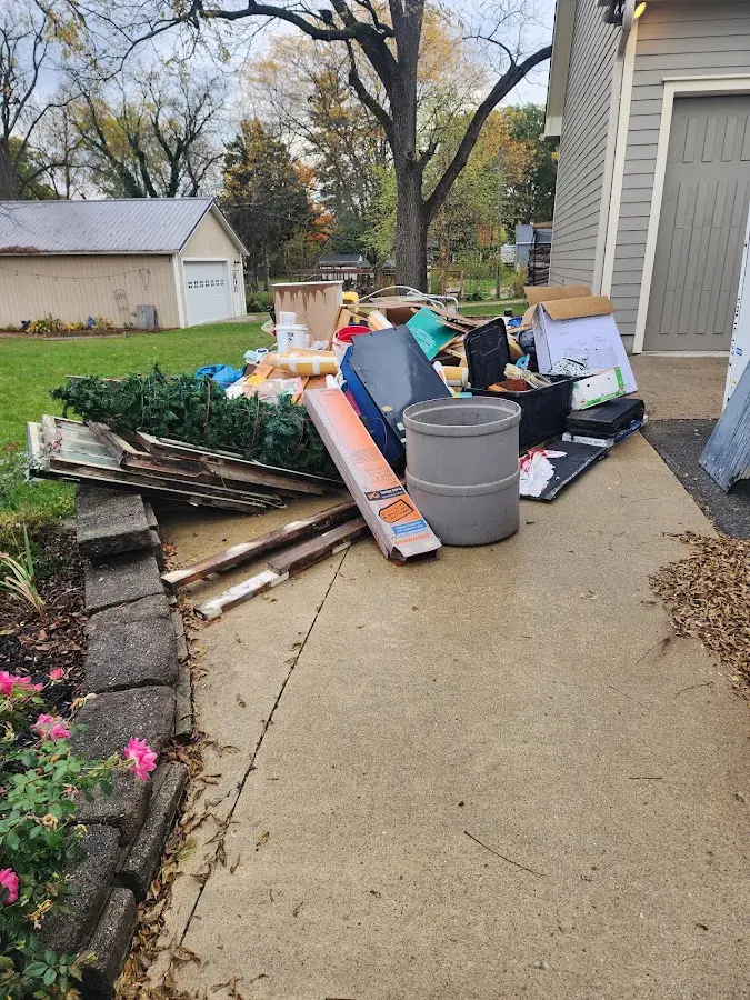 Dumpster being loaded with debris for Commercial Dumpster Rental in Madison Heights